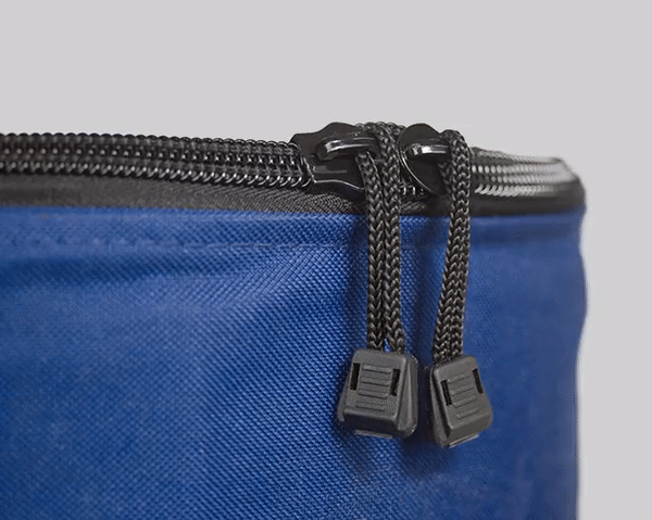 A close up of the zipper on a blue bag